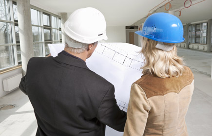 Engineers looking at blueprints