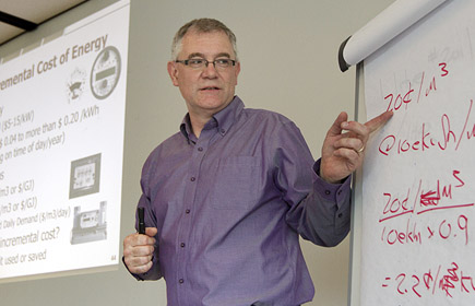 A speaker discussing the cost of energy