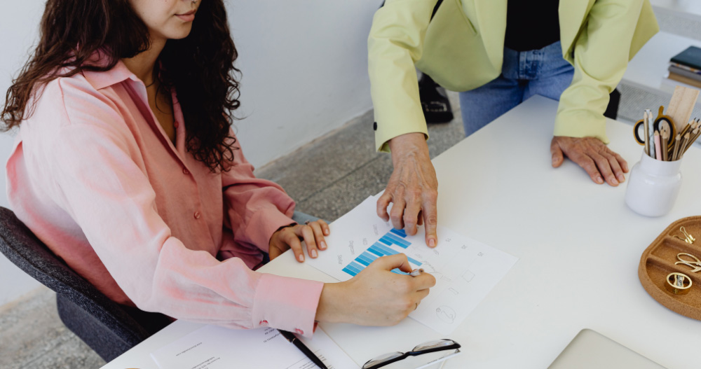Office team examining a set of documents laid out on a desk